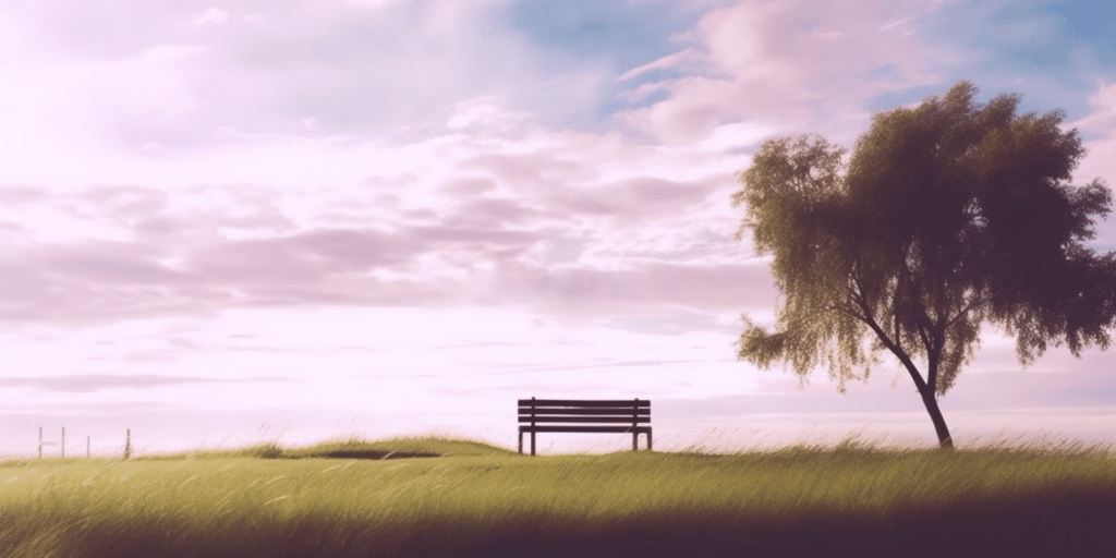 Banc sur une plaine à côté d'un arbre